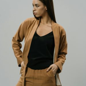 Woman wearing camel tailored pants and matching jacket