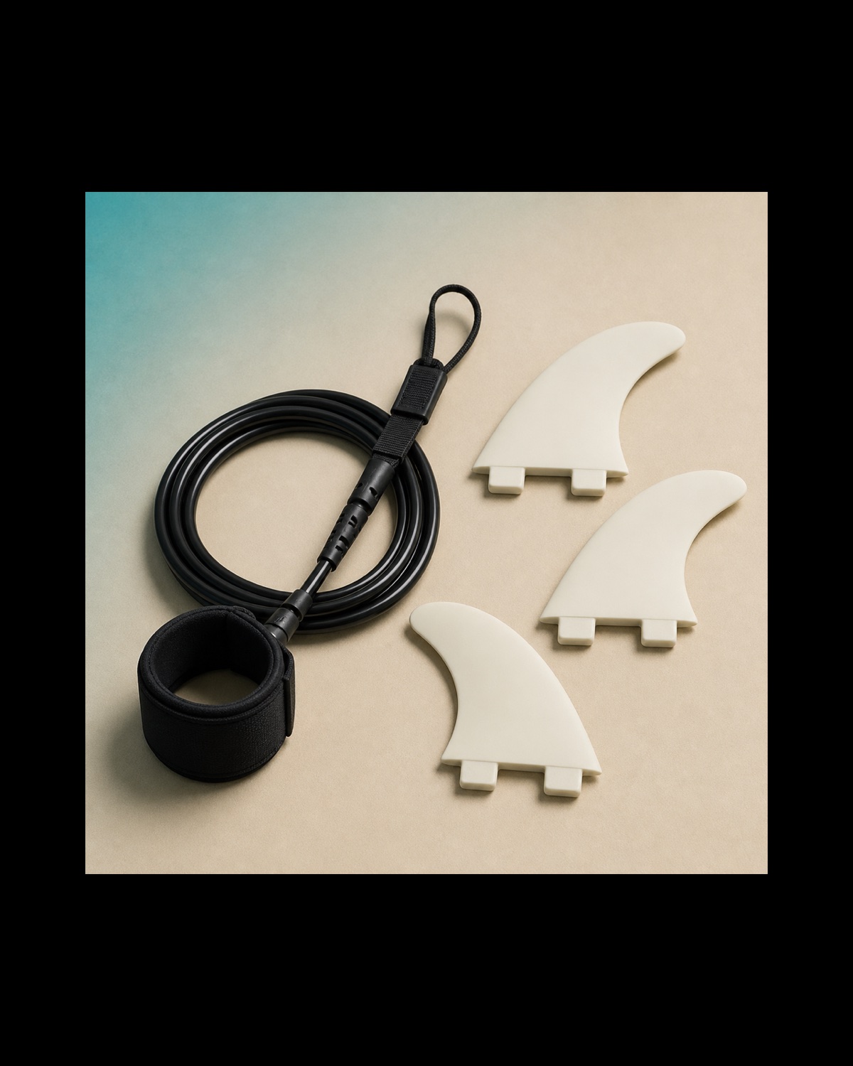 A coiled surfboard leash beside a set of fins