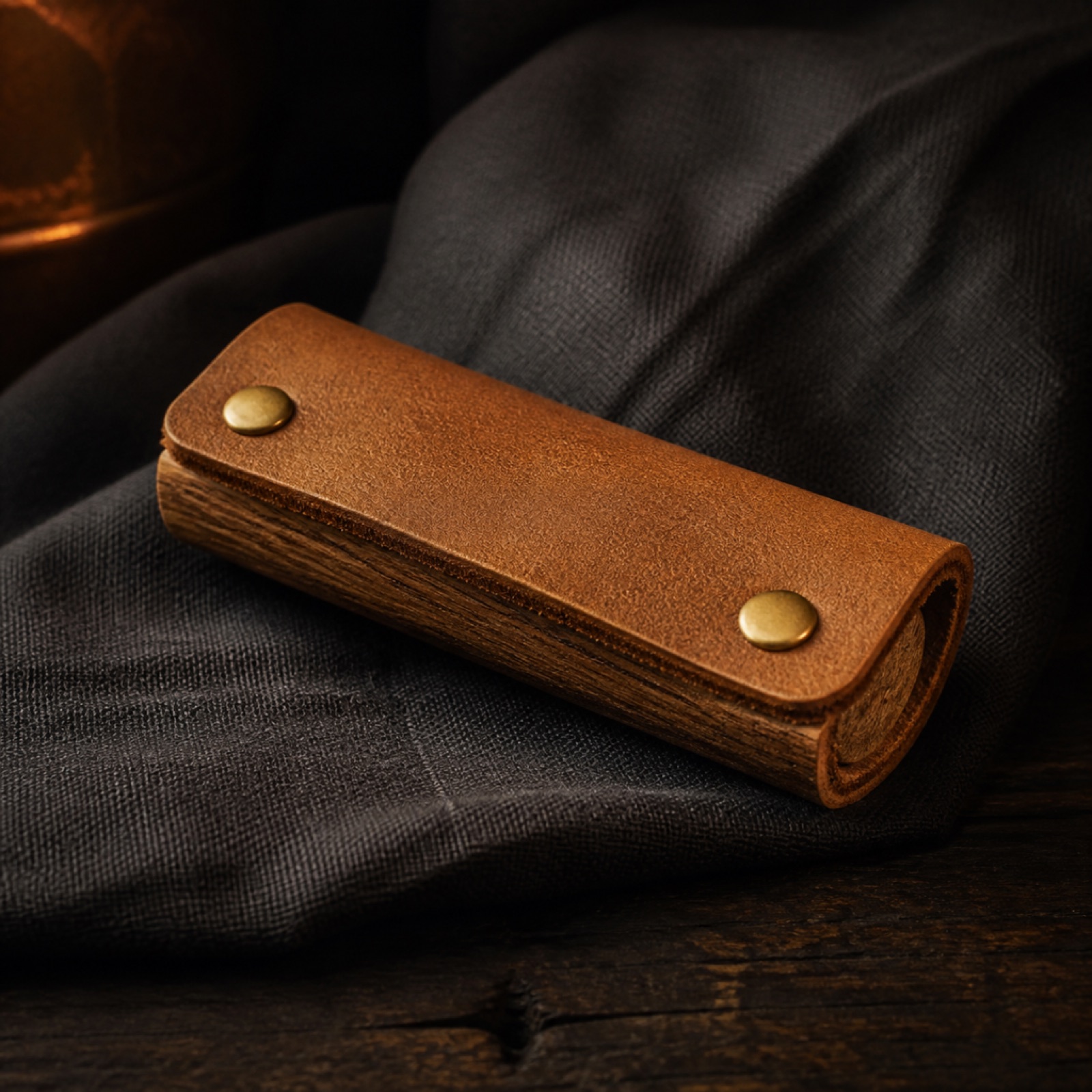 A leather and oak handle cover for a cast iron pan