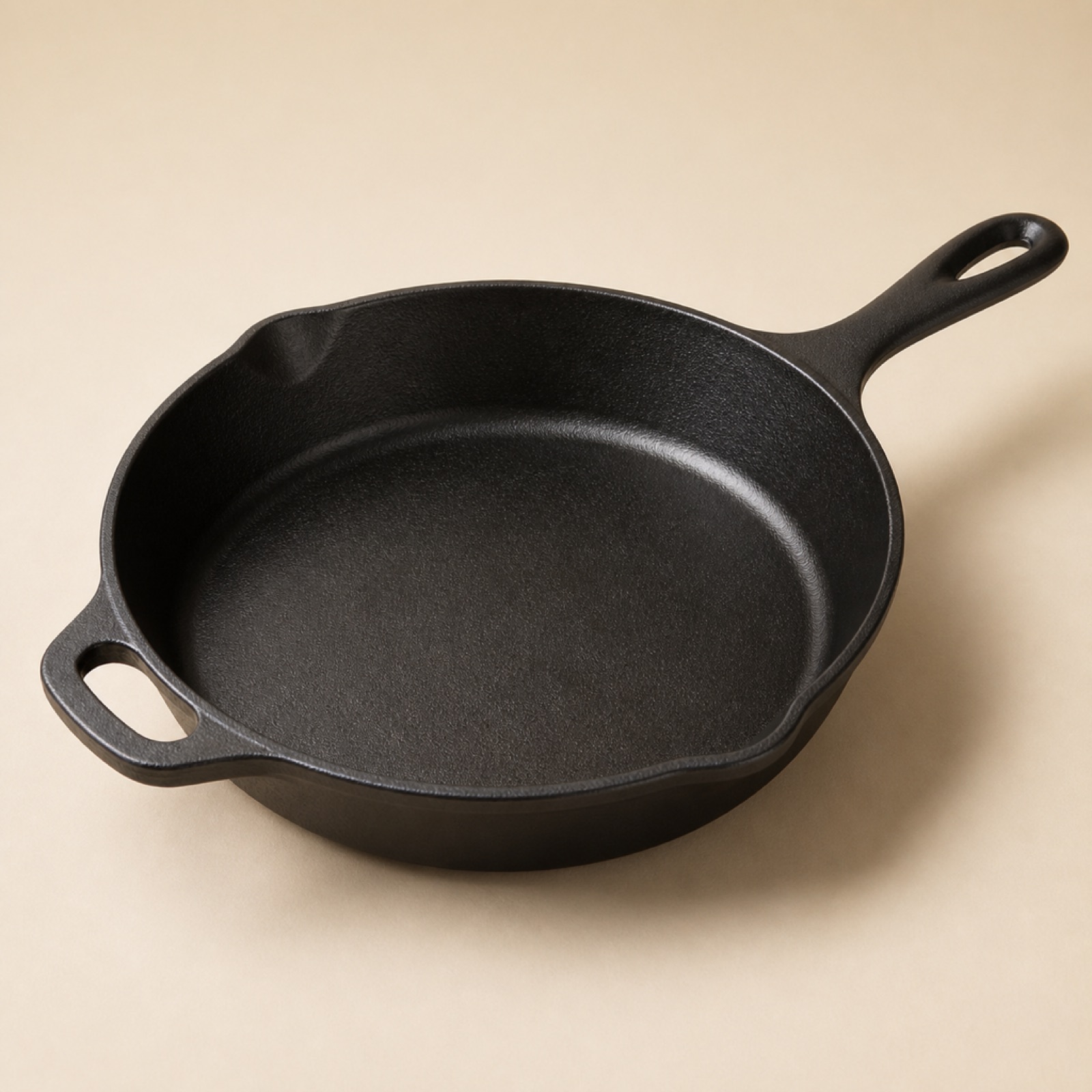 A ten inch cast iron skillet with a warm seasoned face