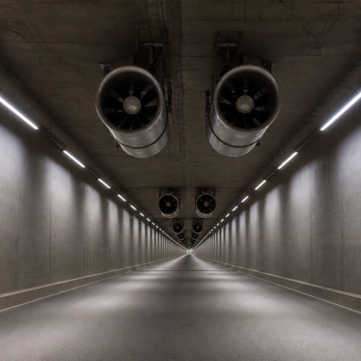 Road tunnel interior with jet fans mounted along the ceiling