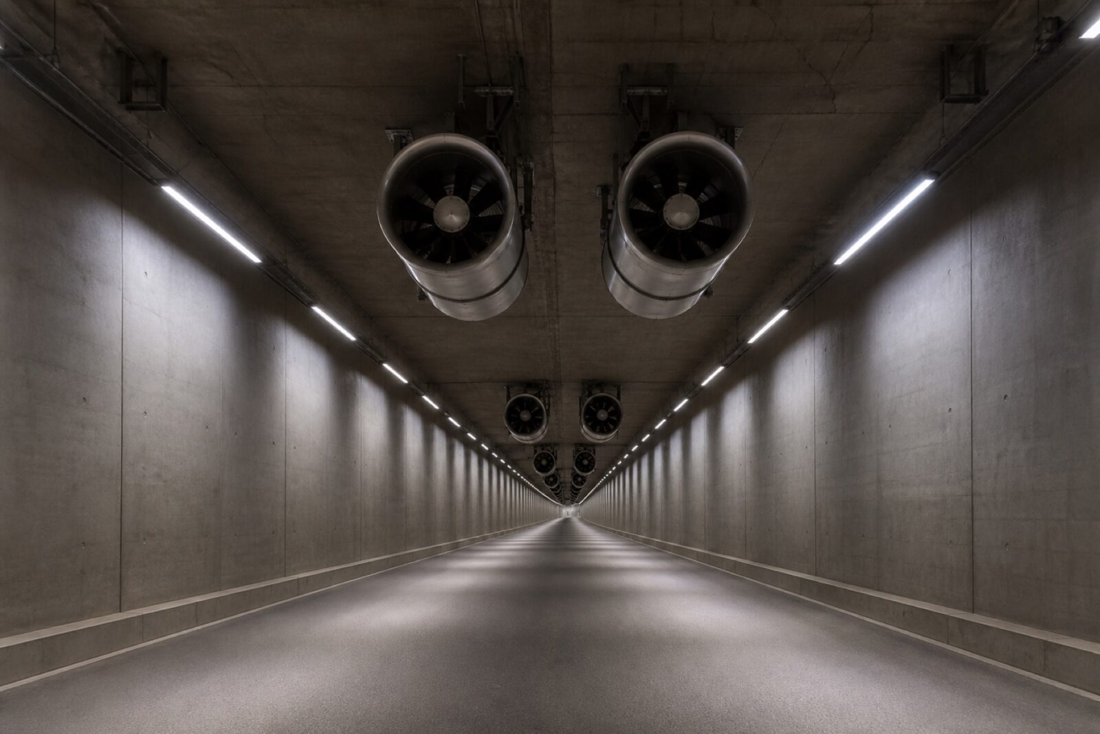 Road tunnel interior with jet fans mounted along the ceiling