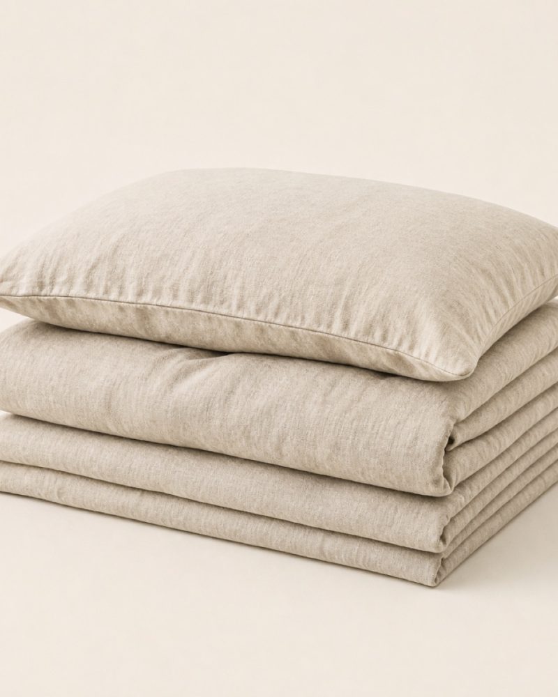 Folded washed linen duvet cover with a matching pillowcase resting on top