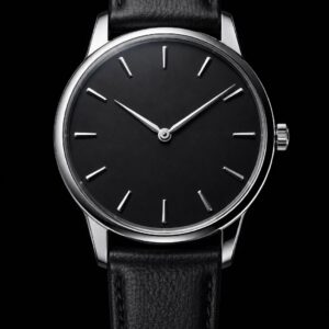 Steel dress watch with a matte black dial and black leather strap, front view on black