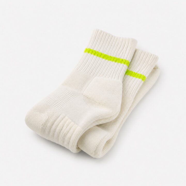 Pair of cream ribbed crew running socks with a single lime stripe at the cuff